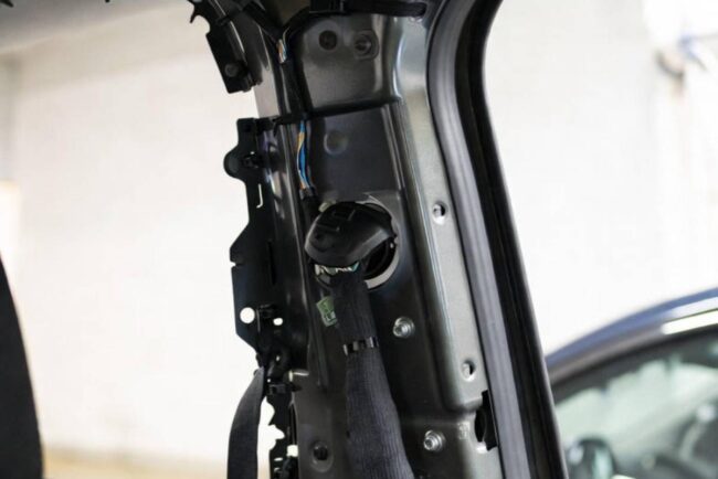 showing the correct routing of the wire BEHIND the airbag